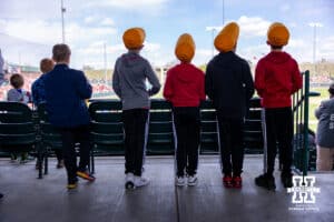 Nebraska Cornhusker fans watching the game against the Southern California Trojans with their corn hats during a college baseball game on Saturday, April 18, 2026, in Lincoln, Neb. Photo by John S. Peterson.