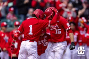 Nebraska Cornhusker Dylan Carey (15) celebrates his home run with Jett Buck (1) and the bat boy against the Southern California Trojans in the third inning during a college baseball game on Saturday, April 18, 2026, in Lincoln, Neb. Photo by John S. Peterson.