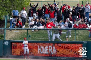 Nebraska Cornhusker fan celebrates catching the Dylan Carey home run ball in the third inning against Southern California Trojan outfielder Will Stickney (40) during a college baseball game on Saturday, April 18, 2026, in Lincoln, Neb. Photo by John S. Peterson.
