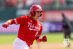 Nebraska Cornhusker Drew Grego (10) runs home to scoring a run from Josh Overbeek's single in the first inning against the Southern California Trojans during a college baseball game on Saturday, April 18, 2026, in Lincoln, Neb. Photo by John S. Peterson.