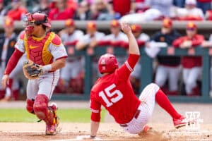 Nebraska Cornhusker Dylan Carey (15) slides home for a run against the Southern California Trojans in the first inning during a college baseball game on Saturday, April 18, 2026, in Lincoln, Neb. Photo by John S. Peterson.