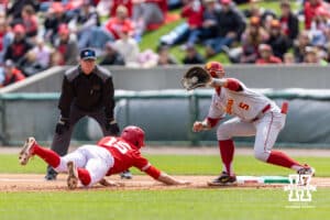 Nebraska Cornhusker infielder Dylan Carey (15) dives back to first against Southern California Trojan infielder Adrian Lopez (5) in the first inning during a college baseball game on Saturday, April 18, 2026, in Lincoln, Neb. Photo by John S. Peterson.