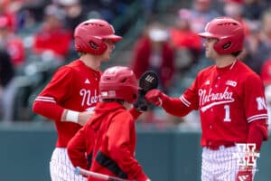 Nebraska Cornhusker Mac Moyer (17) gets a fist bump from Jett Buck (1) after scoring a run against the Southern California Trojans during a college baseball game on Saturday, April 18, 2026, in Lincoln, Neb. Photo by John S. Peterson.