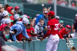 Nebraska Cornhusker Jace Ziola (33) tosses a foul ball to the fans in the first inning during a college baseball game against the Southern California Trojans on Saturday, April 18, 2026, in Lincoln, Neb. Photo by John S. Peterson.