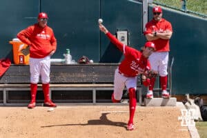 Nebraska Cornhusker starting pitcher Carson Jasa (39) warms up as coaches Rob Childress and Kyle Nicholson watch before a college baseball game against the Southern California Trojans on Saturday, April 18, 2026, in Lincoln, Neb. Photo by John S. Peterson.