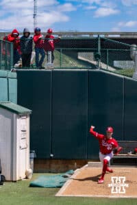 Young Nebraska Cornhusker fans watching pitcher Blake Sebastian (44) throwing pitches in the bullpen before a college baseball game against the Southern California Trojans on Saturday, April 18, 2026, in Lincoln, Neb. Photo by John S. Peterson.
