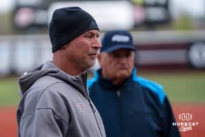 Omaha Softball head coach Mike Heard meets at the plate during a college softball game against South Dakota State on April 18, 2026, in Omaha, Nebraska. Photo by Brandon Tiedemann