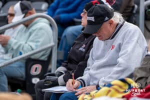 An Omaha Softball fan writes in his book during a college softball game against South Dakota State on April 18, 2026, in Omaha, Nebraska. Photo by Brandon Tiedemann