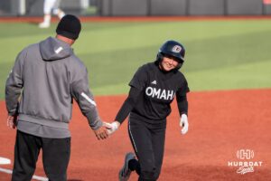Omaha Softball Marra Cramer (9) celebrates a home run with head coach Mike Heard during a college softball game against South Dakota State on April 18, 2026, in Omaha, Nebraska. Photo by Brandon Tiedemann