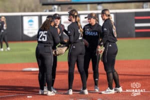 Omaha Softball meets at the mound during a college softball game against South Dakota State on April 18, 2026, in Omaha, Nebraska. Photo by Brandon Tiedemann