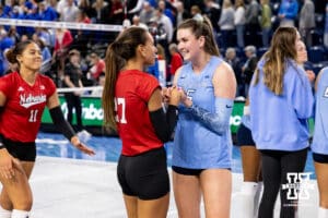 Nebraska Cornhusker outside hitter Harper Murray (27) and Creighton Bluejay middle blocker Ayden Ames (5) share a moment after the match during a college volleyball match on Friday, April 17, 2026, in Omaha, Neb. Photo by John S. Peterson.