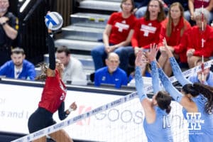 Nebraska Cornhusker outside hitter Skyler Pierce (21) spikes the ball against Creighton Bluejay middle blockers Eloise Brandewie (10) and Jaya Johnson (6) during a college volleyball match on Friday, April 17, 2026, in Omaha, Neb. Photo by John S. Peterson.
