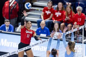 Nebraska Cornhusker outside hitter Teraya Sigler (11) spikes the ball against Creighton Bluejay middle blockers Eloise Brandewie (10) and Ayden Ames (5) in the third set during a college volleyball match on Friday, April 17, 2026, in Omaha, Neb. Photo by John S. Peterson.