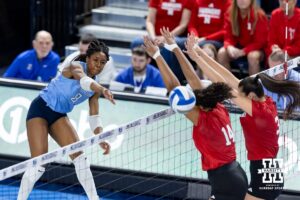 Creighton Bluejay outside hitter Trinity Shadd-Ceres (8) spikes the ball against Nebraska Cornhuskers Manaia Ogbechie (14) and Virginia Adriano (3) in the second set during a college volleyball match on Friday, April 17, 2026, in Omaha, Neb. Photo by John S. Peterson.