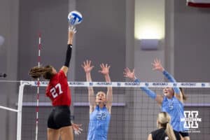 Nebraska Cornhusker outside hitter Harper Murray (27) tips the ball against Creighton Bluejays Ashlyn Paymal (22) and Ayden Ames during a college volleyball match on Friday, April 17, 2026, in Omaha, Neb. Photo by John S. Peterson.