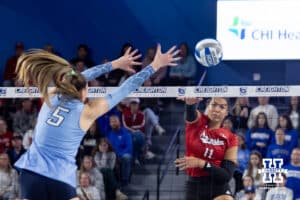 Nebraska Cornhusker outside hitter Teraya Sigler (11) spikes the ball against Creighton Bluejay middle blocker Ayden Ames (5) in the first set during a college volleyball match on Friday, April 17, 2026, in Omaha, Neb. Photo by John S. Peterson.