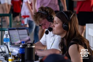 Nebraska Cornhusker softball player Lauren Camenzind is calling the game against the Creighton Bluejays for the student radio station during a college baseball game on Tuesday, April 14, 2026, in Lincoln, Neb. Photo by John S. Peterson.