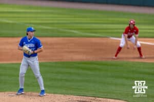 Creighton Bluejay pitcher Evan Stratton (17) is ready to throw a pitch with Nebraska Cornhusker Dylan Carey (15) leading off in the third during a college baseball game on Tuesday, April 14, 2026, in Lincoln, Neb. Photo by John S. Peterson.