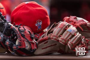 Nebraska Cornhuskers gloves and a hat are stacked in the dugout against the Creighton Bluejays during a college baseball game on Tuesday, April 14, 2026, in Lincoln, Neb. Photo by John S. Peterson.