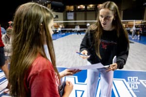 Nebraska Cornhusker setter Bergen Reilly (2) signs an autograph after the win against the Iowa State Cyclones during a college volleyball match on Saturday, April 11, 2026, in Lincoln, Neb. Photo by John S. Peterson.