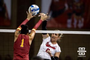 Nebraska Cornhusker middle blocker Kenna Cogill (8) spikes the ball against Iowa State Cyclone middle blocker Pam McCune (1) during a college volleyball match on Saturday, April 11, 2026, in Lincoln, Neb. Photo by John S. Peterson.