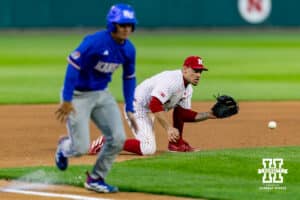 Nebraska Cornhusker infielder Josh Overbeek (4) fields the ball to throw out Kansas Jayhawk Augusto Mungarrieta (21) at home in the sixth inning during a college baseball game on Tuesday, April 7, 2026, in Lincoln. Photo by John S. Peterson.