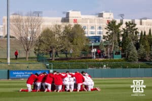 Nebraska Cornhuskers huddle up before taking on the Kansas Jayhawks during a college baseball game on Tuesday, April 7, 2026, in Lincoln. Photo by John S. Peterson.