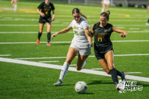 Pius’ Molly Kotschwar (21) battles for the ball against Gretna East’s Izzie Kahm (14) during a high school girls soccer game Monday, March 30, 2026, in Gretna, Nebraska. Photo by Jackson D. Luethje.