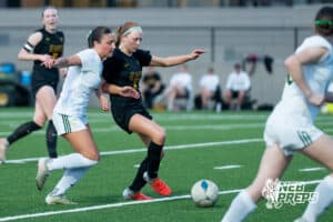 Gretna East’s Taylor LaRock (5) dribbles the ball against Pius’ Margaret O’Donnell (3) during a high school girls soccer game Monday, March 30, 2026, in Gretna, Nebraska. Photo by Jackson D. Luethje.