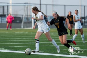 Pius’ Kate Miller (33) dribbles the ball against Gretna East’s Avery Brabban (15) during a high school girls soccer game Monday, March 30, 2026, in Gretna, Nebraska. Photo by Jackson D. Luethje.