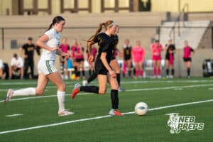 Gretna East’s Avery Brabban (15) dribbles past a Pius defender during a high school girls’ soccer game Monday, March 30, 2026, in Gretna, Nebraska. Photo by Jackson D. Luethje.