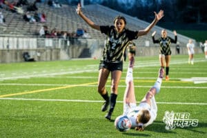 Southwest’s Ansley Throener (9) is tripped up by Southeast’s Avaerie Graves (2) during a high school girls’ soccer game Tuesday, March 31, 2026, in Lincoln, Nebraska. Photo by Jackson D. Luethje.