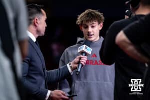 Nebraska Cornhusker Nathan York is being interviewed after being awarded first place on the parallel bars during the Big Ten Men’s Gymnastics Championships on Saturday, April 4, 2026, in Lincoln. Photo by John S. Peterson.