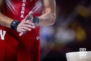 Nebraska Cornhusker Nik Tarca chalks up his hand before performing on the pommel horse during the Big Ten Men's Gymnastics Team Championship on Friday, April 3, 2026, in Lincoln. Photo by John S. Peterson.