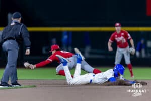 Creighton Bluejay base runner Rocco Gump (15) dives back to second to tag up against the Nebraska Cornhuskers in the ninth inning during a college baseball game on Tuesday, March 31, 2026, in Omaha. Photo by John S. Peterson.