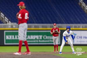 Creighton Bluejay base runner Chris Baillargeon (22) leads off second as Nebraska Cornhusker pitcher Pryce Bender (6) check on him in the sixth inning during a college baseball game on Tuesday, March 31, 2026, in Omaha. Photo by John S. Peterson.