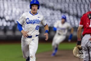 Creighton Bluejay base running Nick Bowron (10) and Teddy Deters scores in the sixth inning against the Nebraska Cornhuskers during a college baseball game on Tuesday, March 31, 2026, in Omaha. Photo by John S. Peterson.