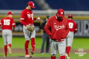 Nebraska Cornhuskers pitching coach Rob Childress walks to the dugout after making a visit with Caleb Clark (24) in the fifth inning against the Creighton Bluejays during a college baseball game on Tuesday, March 31, 2026, in Omaha. Photo by John S. Peterson.
