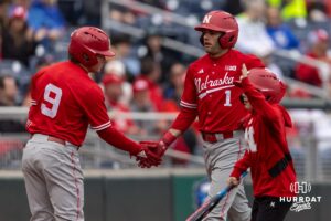 Nebraska Cornhusker Rhett Stokes (9) and Jett Buck (1) celebrate scoring runs in the second inning against the Creighton Bluejays during a college baseball game on Tuesday, March 31, 2026, in Omaha. Photo by John S. Peterson.