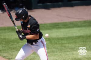 Nebraska Cornhusker Dylan Carey (15) gets hit by a pitch during a regional baseball game against Arizona State on May 31, 2026, in Lincoln, Nebraska. Photo by Brandon Tiedemann.