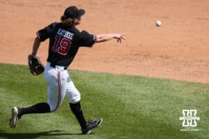 Nebraska Cornhusker Cooper Katskee (19) flips the ball to first base during a regional baseball game against Arizona State on May 31, 2026, in Lincoln, Nebraska. Photo by Brandon Tiedemann.
