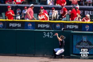 Nebraska Cornhusker Drew Grego (10) runs into the wall during a regional baseball game against Arizona State on May 31, 2026, in Lincoln, Nebraska. Photo by Brandon Tiedemann.