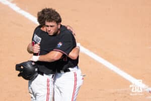 Nebraska Cornhuskers hug during a regional baseball game against Arizona State on May 31, 2026, in Lincoln, Nebraska. Photo by Brandon Tiedemann.