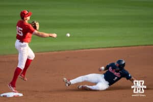 Nebraska Cornhusker Dylan Carey (15) throws to first base during a regional baseball game against Ole Miss on May 30, 2026, in Lincoln, Nebraska. Photo by Brandon Tiedemann.