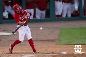 Nebraska Cornhusker Rhett Stokes (9) hits the ball during a regional baseball game against Ole Miss on May 30, 2026, in Lincoln, Nebraska. Photo by Brandon Tiedemann.