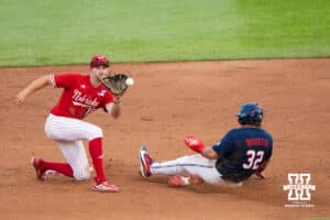Nebraska Cornhusker Dylan Carey (15) tries to tag a runner during a regional baseball game against Ole Miss on May 30, 2026, in Lincoln, Nebraska. Photo by Brandon Tiedemann.