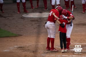 Nebraska Cornhuskers huddle at home plate during a regional baseball game against Ole Miss on May 30, 2026, in Lincoln, Nebraska. Photo by Brandon Tiedemann.