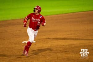 Nebraska Cornhusker Max Buettenback (11) rounds the bases during a regional baseball game against Ole Miss on May 30, 2026, in Lincoln, Nebraska. Photo by Brandon Tiedemann.