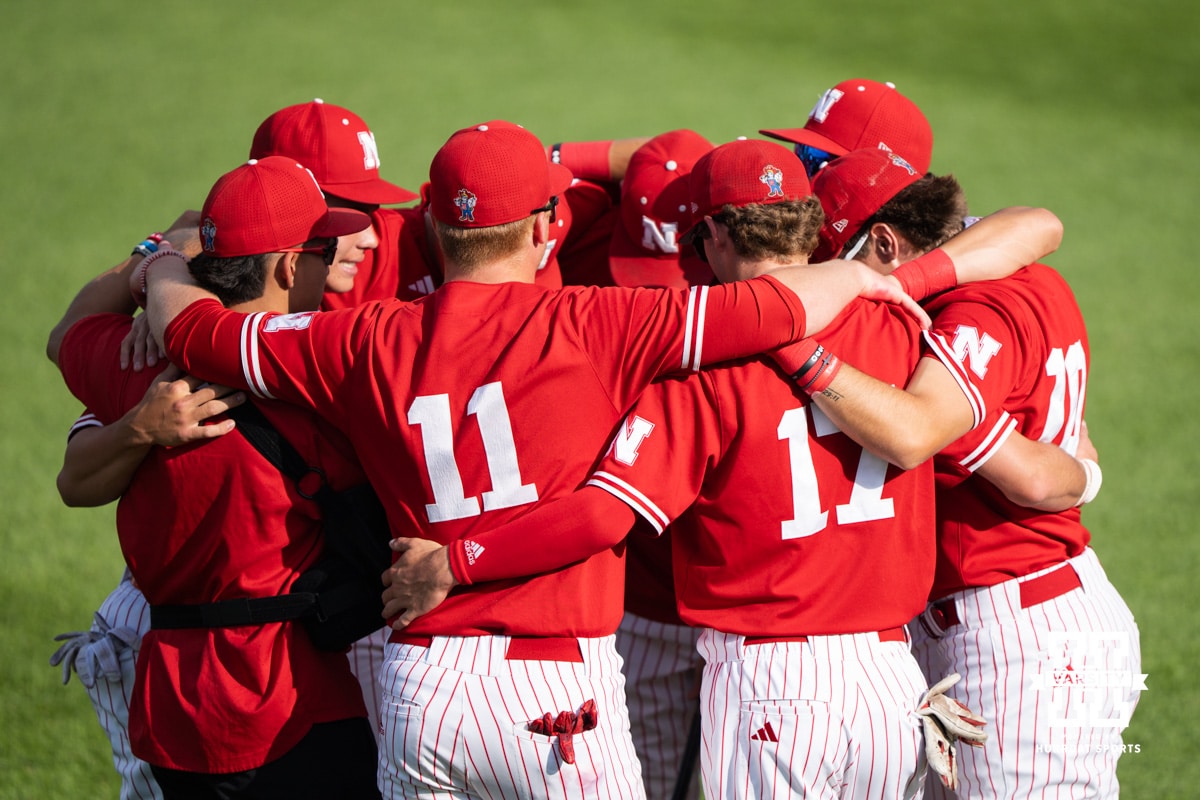 Nebraska Cornhuskers huddle up before a regional baseball game against Ole Miss on May 30, 2026, in Lincoln, Nebraska. Photo by Brandon Tiedemann.