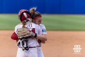 Alabama Crimson Tide starting pitcher Jocelyn Briski (23) and catcher Marlie Giles (34) hug after the win over the Nebraska Cornhuskers during the WCWS second round on Saturday, May 30, 2026, in Oklahoma City. Photo by John S. Peterson.